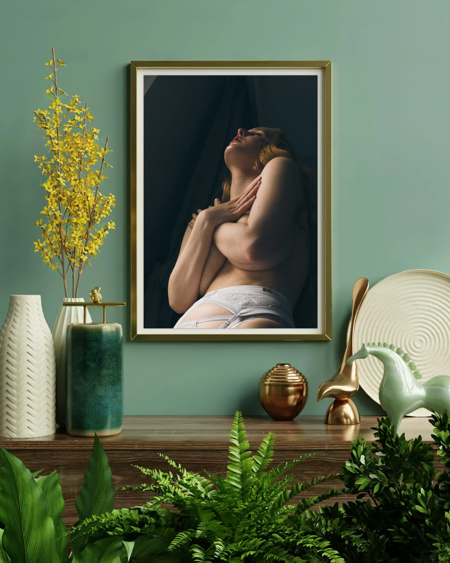 A photo of a beautifully-printed boudoir photograph framed and hung on a wall